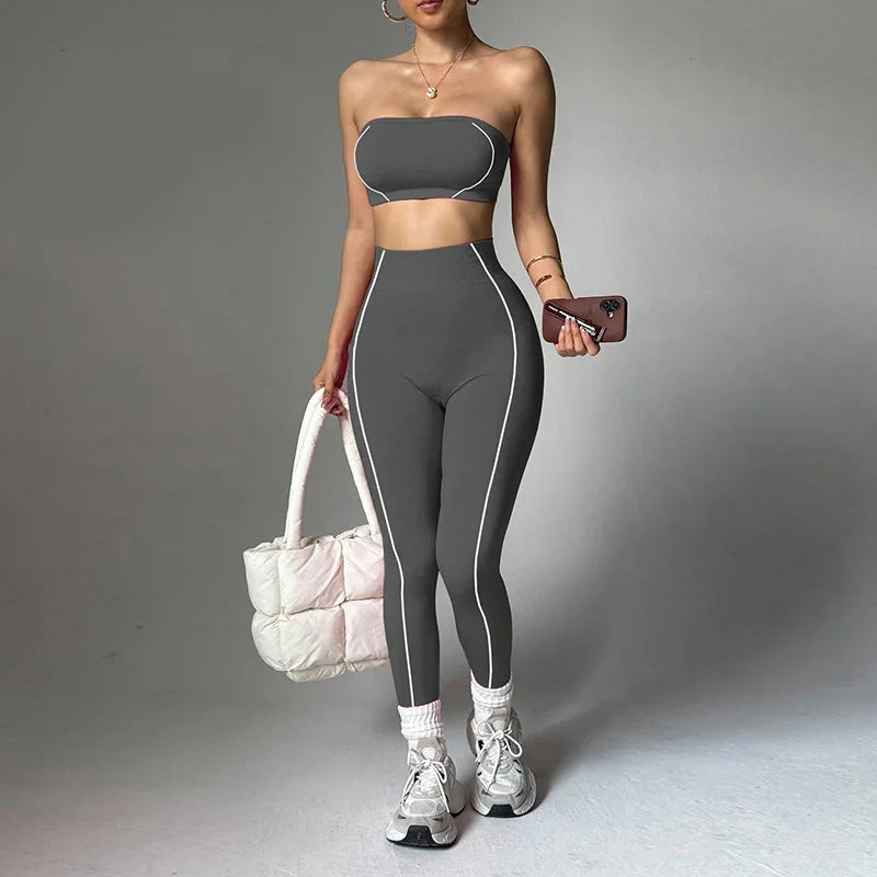 Women's yoga wear set by ALMASTRONG featuring a color-blocking peach corset top and slim-fit long pants for fitness.